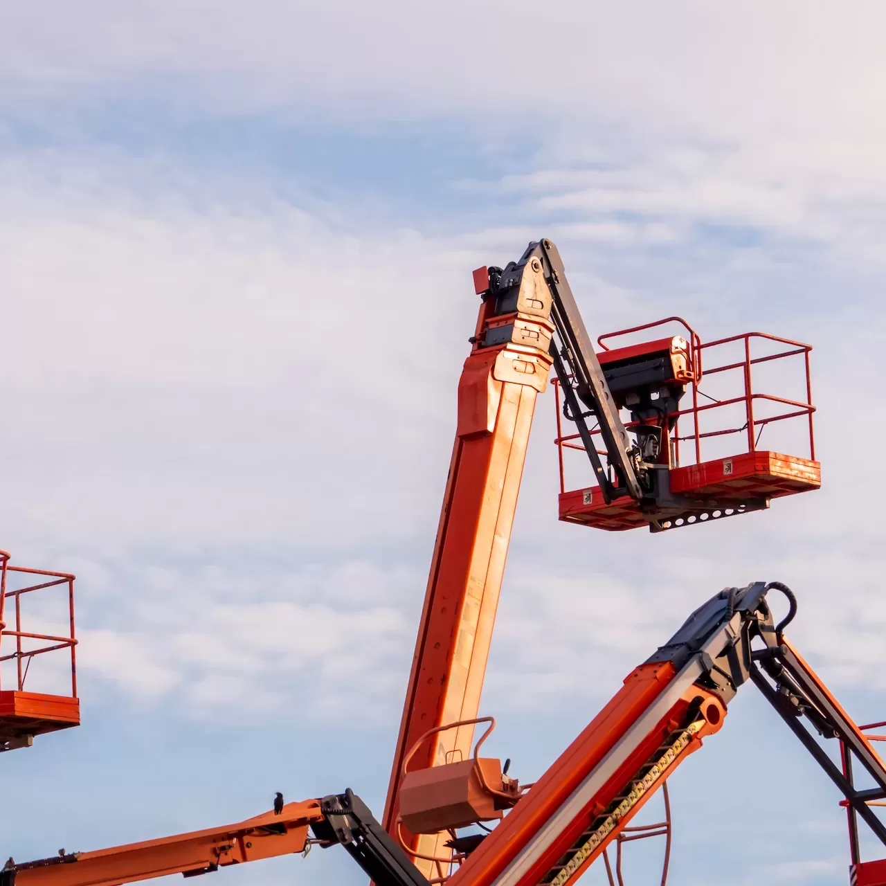 Articulated boom lift. Aerial platform lift. Telescopic boom lift against blue sky. Mobile construction crane for rent and sale. Maintenance and repair hydraulic boom lift service. Crane dealership.