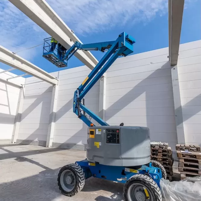 Warehouse construction site. Building a new industrial hall or storehouse. Mobile elavating work platform vehicle